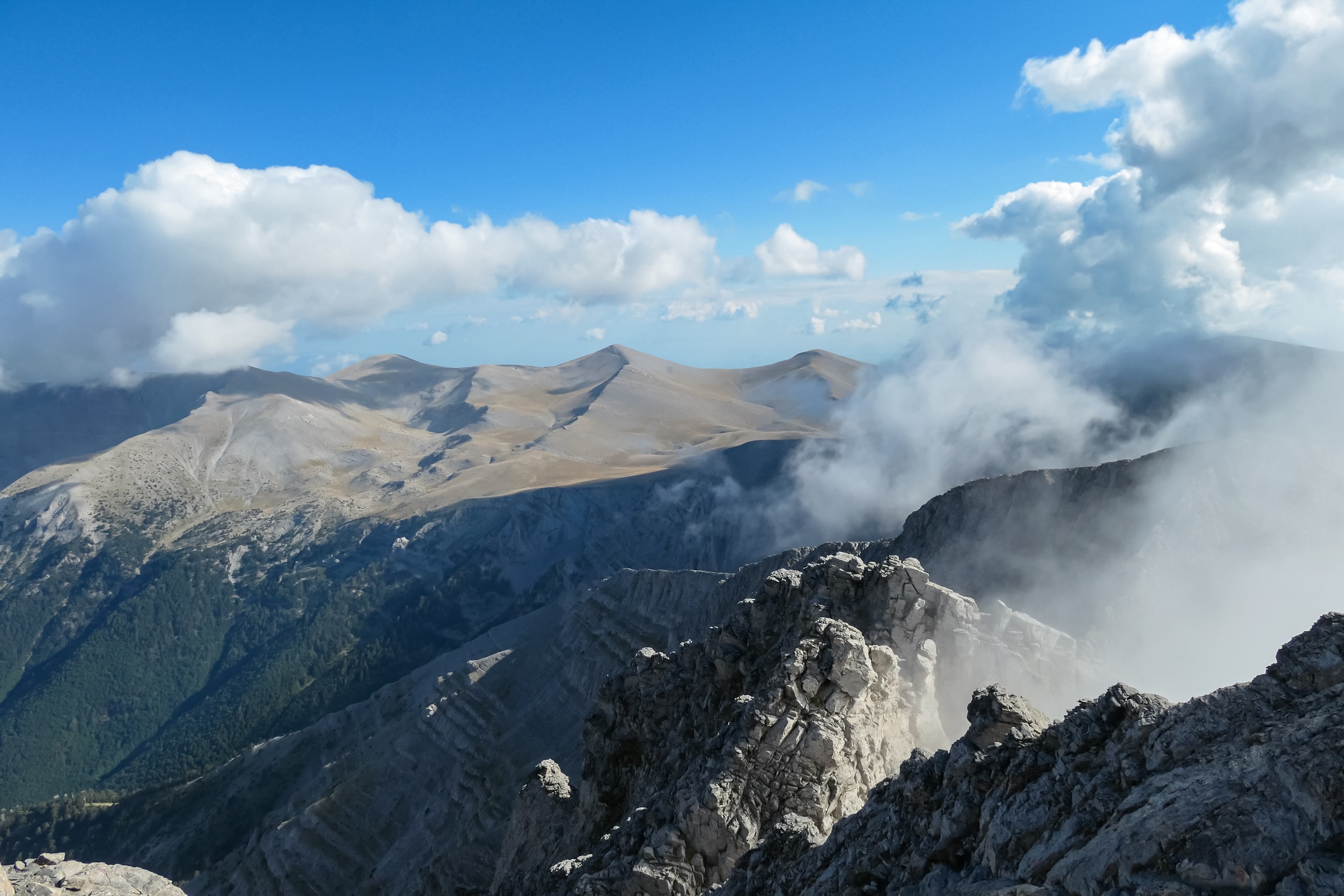 Panoramic view from cloud covered mountain summit of Mytikas Mount Olympus