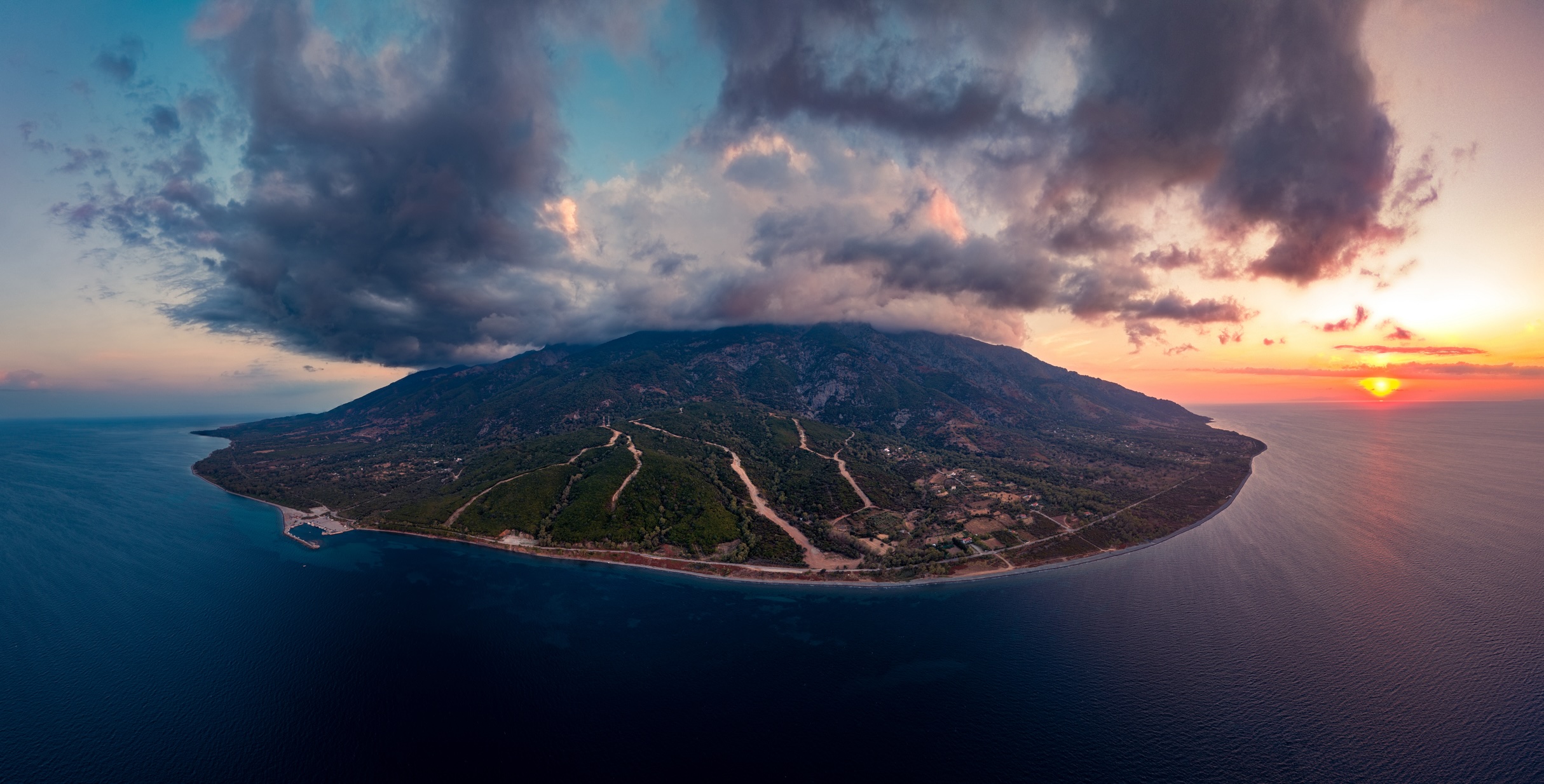 Aerial panoramic photo of Therma, the villages nearby, the port of Therma and mount Saos in Samothraki island, Samothrace, Aegean sea, Greece,  at summer, at dusk.