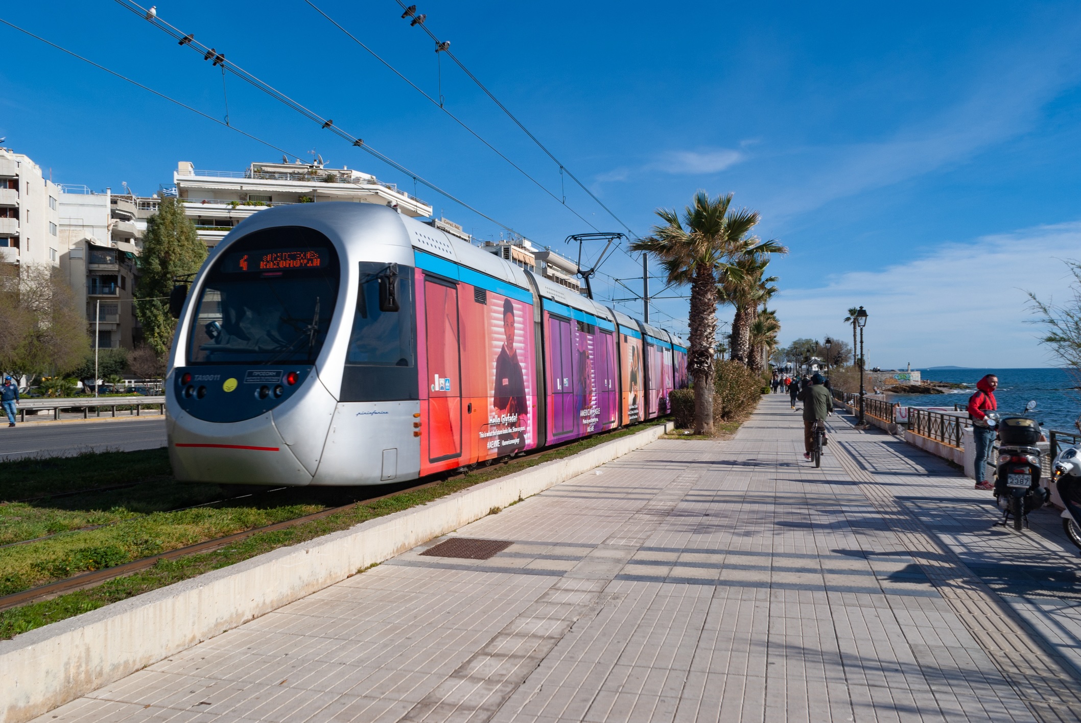 Athens, Greece: waterfront reviera with tram and people walking