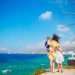 Happy family in front of windmills at popular tourist area on Mykonos island, Greece