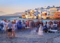 Crowd of people watching sunset in little Venice - city of Mykonos - Greece