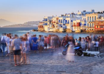 Crowd of people watching sunset in little Venice - city of Mykonos - Greece