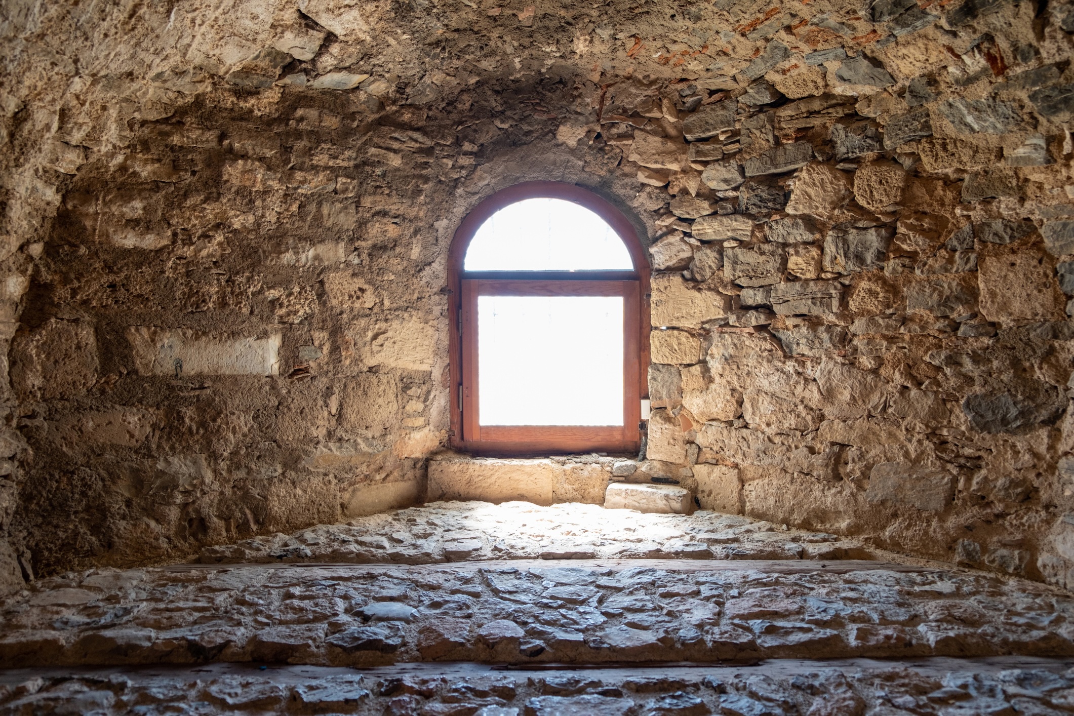 Greece, Kanithos or Karababa Castle at Chalkida. View of interior stonewall fort, arched window.