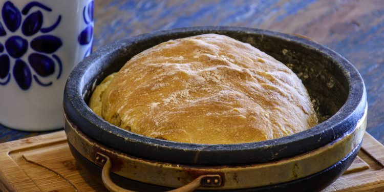 Fresh homemade bread with organic ingredients over rustic table