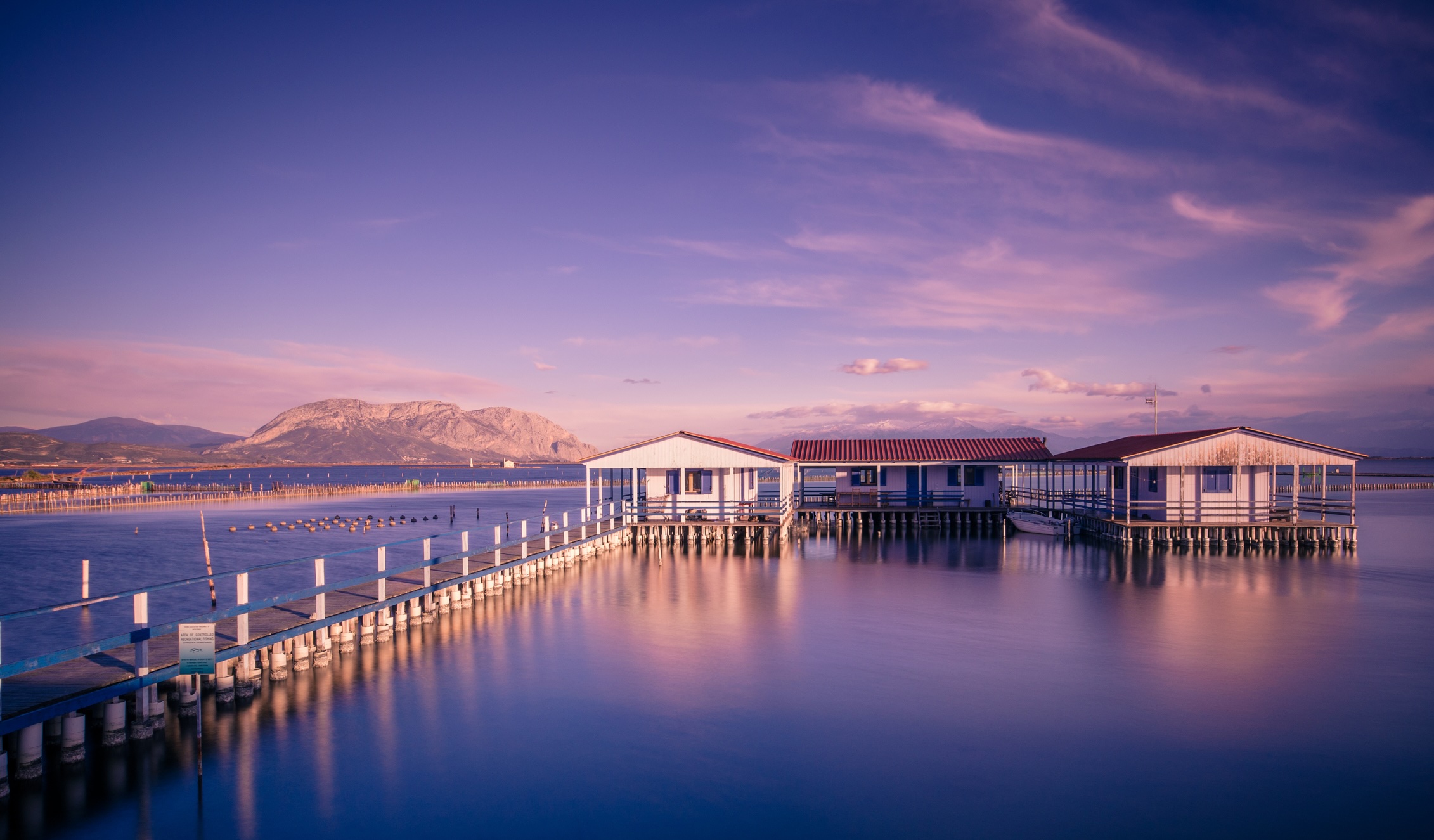 Small fishing houses on stilts on the lake Mesologgi.