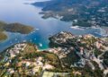 View from above, stunning aerial view of a bay with boats and luxury yachts sailing on a turquoise, clear water. Syvota, Greece.