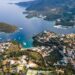 View from above, stunning aerial view of a bay with boats and luxury yachts sailing on a turquoise, clear water. Syvota, Greece.