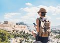 Woman using smart phone on vacations in Athens
