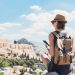 Woman using smart phone on vacations in Athens