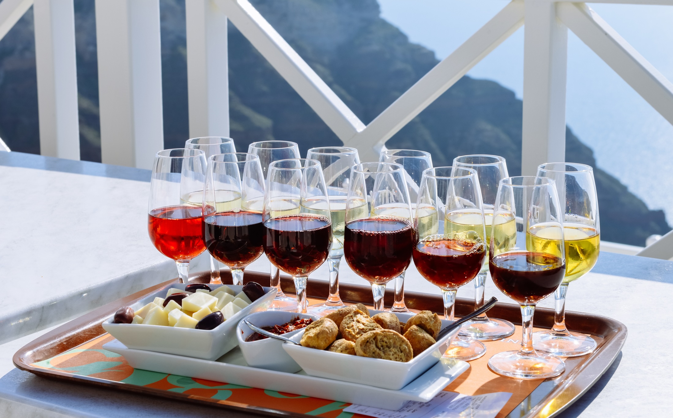 wine and snacks on outdoor table by the sea